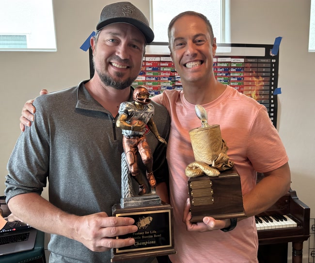 The 2024 champion and Toilet Bowl trophies, held by their winners